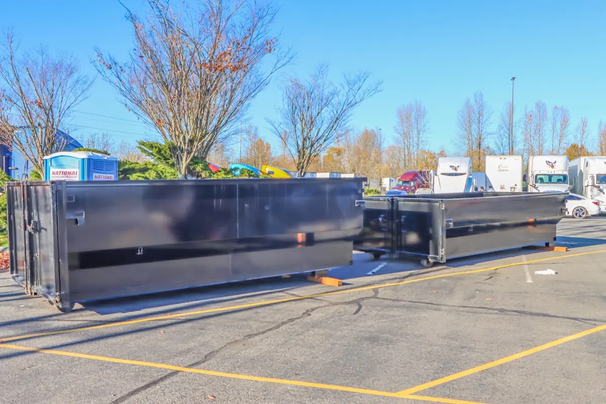 Professional dumpster rental service with roll-off container on residential driveway in Meredith